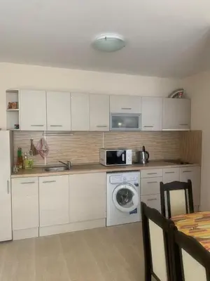 a kitchen with a washing machine and a microwave at Balkan Breeze 7 - Rey&Mar Apartaments in Sunny Beach