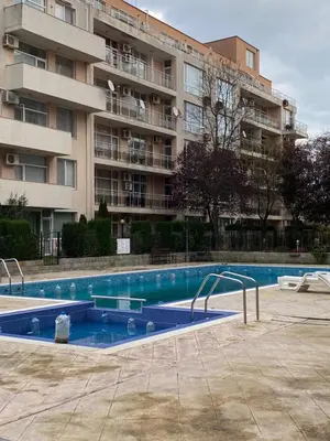 a swimming pool in front of a large apartment building at Balkan Breeze 7 - Rey&Mar Apartaments in Sunny Beach