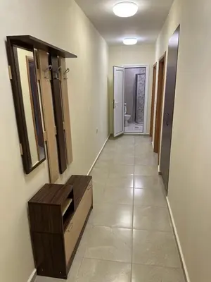 a hallway with a vanity and mirrors in a bathroom at Apartment near the sea in Pomorie