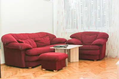 a living room with a red couch and a table at Relax in Lazur - Georgi Baev Str in Burgas City