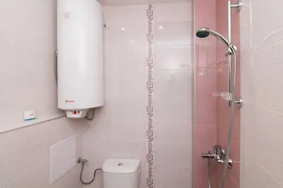 a bathroom with a shower and a toilet with a tank at Relax in Lazur - Georgi Baev Str in Burgas City
