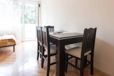 a dining room table and chairs in a room at Relax in Lazur - Georgi Baev Str in Burgas City