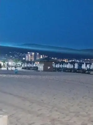 a group of chairs and tables on a beach at Villa Valencja Apartments in Sunny Beach