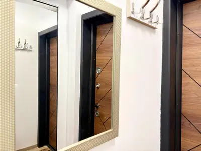 a mirror on a wall with a door at Skyline Loft in Varna City