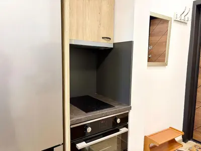 a small kitchen with an oven in a room at Skyline Loft in Varna City