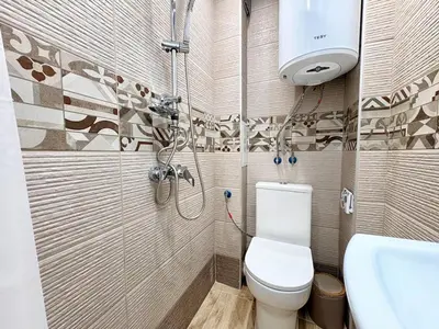 a bathroom with a shower and a toilet and a sink at Skyline Loft in Varna City