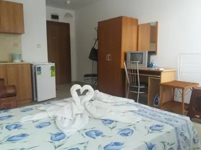 a bedroom with a bed with swans made out of towels at Студио Наде in Tsarevo