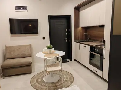a small kitchen with a table and a chair at SOHO apartments in Burgas City
