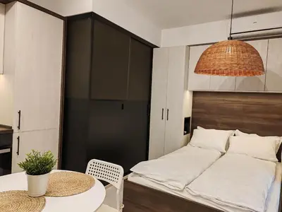 a bedroom with a bed and a table and a table and chairs at SOHO apartments in Burgas City