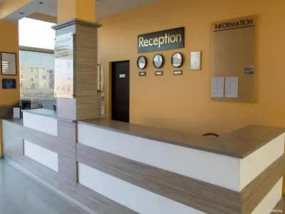a reception area of a hospital with clocks on the wall at Клара апартамент in Burgas City