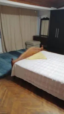 a woman laying on a bed with her legs on it at Апартамент опера in Varna City