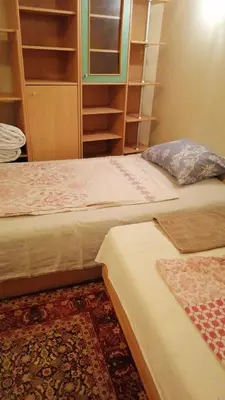 two beds sitting next to each other in a room at Апартамент опера in Varna City