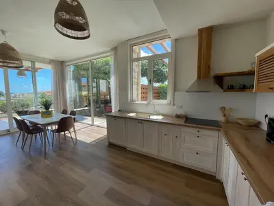 a kitchen with a table and a dining room at Lozenets Luxury Pool Villa by Lozenetsvillas in Lozenets