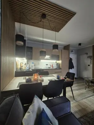 a kitchen and living room with a table and chairs at Villa Valencja Apartments Family in Sunny Beach