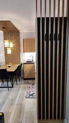 a kitchen and a dining room with a table at Villa Valencja Apartments Family in Sunny Beach