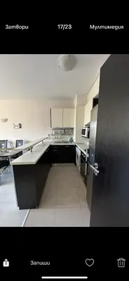 a kitchen with a refrigerator and a counter top at Апартаменти Нино 1 in Sozopol