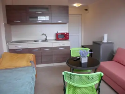 a small living room with a table and a couch at Le studio Summer Breeze in Sunny Beach