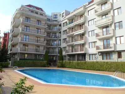 an apartment complex with a swimming pool in front of a building at Le studio Summer Breeze in Sunny Beach