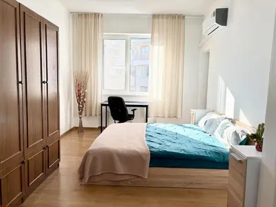 a bedroom with a bed and a desk in it at SeaSide 2BR Central apartment in Varna City