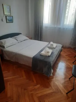 a bedroom with a bed with two towels on it at Guest Rooms Ilko in Varna City