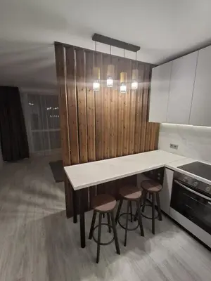 a kitchen with a counter and stools in it at Yana Sanny Beach in Sunny Beach