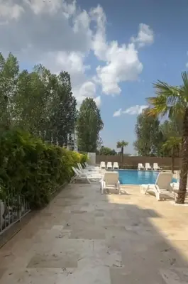 a pool at a resort with white lounge chairs at Yana Sanny Beach in Sunny Beach
