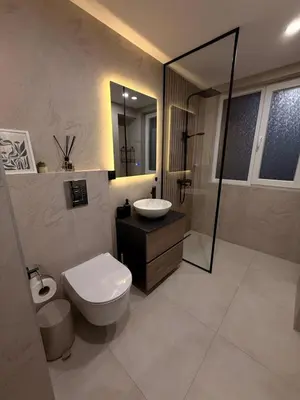 a bathroom with a toilet and a sink and a shower at Seaside Home in Burgas City