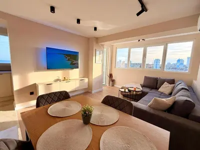 a living room with a couch and a table at Seaside Home in Burgas City