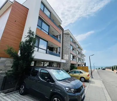 a small car parked in front of a building at Apartment for guests Panorama - first line sea in Burgas City
