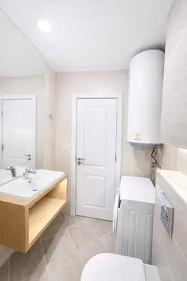 a white bathroom with a toilet and a sink at Harmony Grand Resort 16 Private Apartment 214 in Sunny Beach