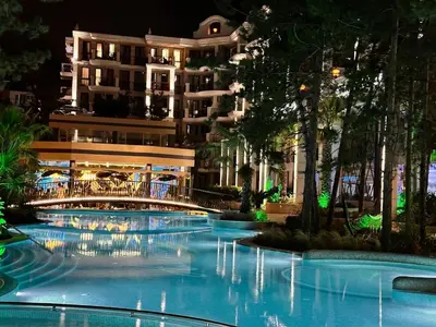 a swimming pool in front of a building at night at Harmony Grand Resort 16 Private Apartment 214 in Sunny Beach