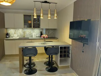 a kitchen with a island with two bar stools at Emperium, Style, Coziness and tranquility by the sea in Sveti Vlas! in Sveti Vlas