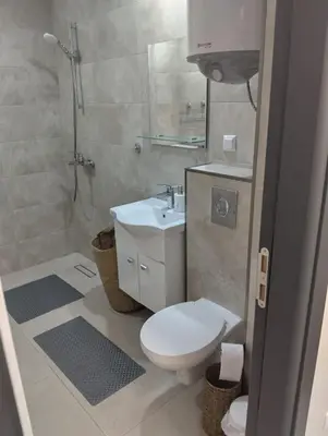 a bathroom with a toilet and a sink and a shower at Emperium, Style, Coziness and tranquility by the sea in Sveti Vlas! in Sveti Vlas