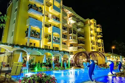 a hotel with a swimming pool in front of a building at Луксозно Студио Сладък Дом в Слънчев бряг in Sunny Beach