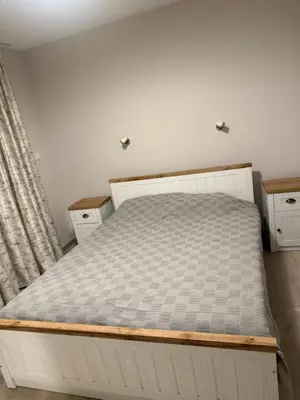 a bed in a room with a bed frame at Valena Royal apartment in Chernomorets