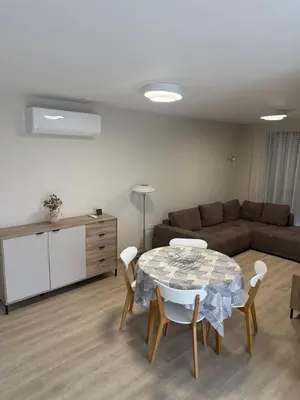 a living room with a table and a couch at Valena Royal apartment in Chernomorets