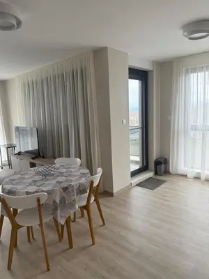 a dining room with a table and chairs in a room at Valena Royal apartment in Chernomorets