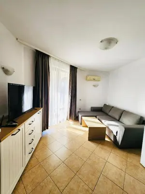 a living room with a couch and a flat screen tv at Spacious apartment with 2 bedrooms and 2 bathrooms complex ROYAL SUN Sunny beach in Sunny Beach