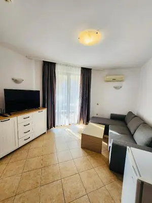 a living room with a couch and a flat screen tv at Spacious apartment with 2 bedrooms and 2 bathrooms complex ROYAL SUN Sunny beach in Sunny Beach