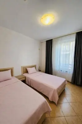 a hotel room with two beds and a window at Spacious apartment with 2 bedrooms and 2 bathrooms complex ROYAL SUN Sunny beach in Sunny Beach