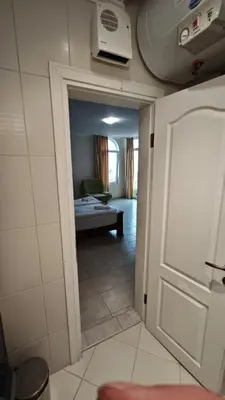 a door leading into a room with a living room at Marina Sunrise Complex by the sea in Sveti Vlas