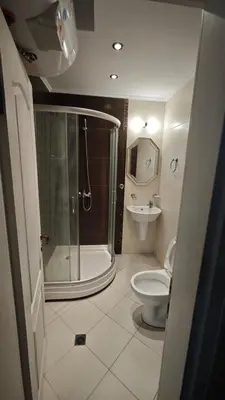 a bathroom with a shower and a toilet and a sink at Marina Sunrise Complex by the sea in Sveti Vlas