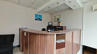 an office with a reception desk in a room at Marina Sunrise Complex by the sea in Sveti Vlas