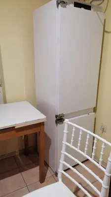 a room with a white door next to a table at Апартамент 27 юли 1 in Varna City