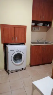 a kitchen with a washing machine and a sink at Апартамент 27 юли 1 in Varna City
