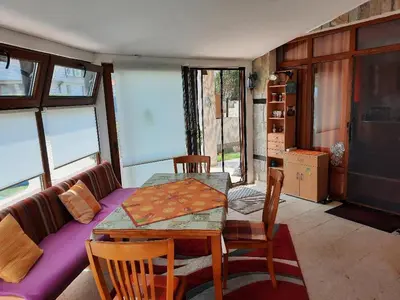 a living room with a table and a couch at Villa Jasmin in Aheloy