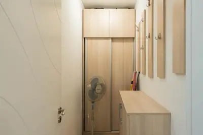 a kitchen with a refrigerator and a fan in a room at Calm space in Varna top center in Varna City