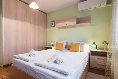 a bedroom with a large bed with white sheets at Calm space in Varna top center in Varna City