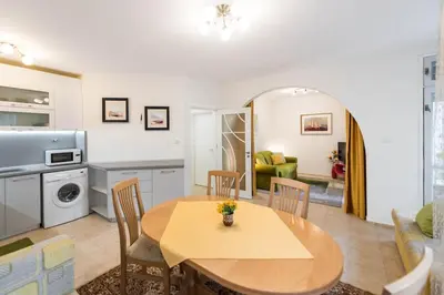 a kitchen and living room with a table and chairs at Calm space in Varna top center in Varna City