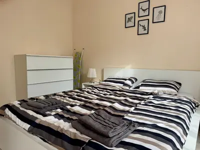 a bedroom with a bed with towels on it at Above the Sea Luxury Apartment in Varna City